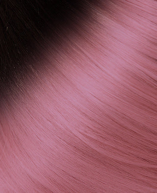 A close-up of a pink and black hair-coloured hair extension from Halo Couture.